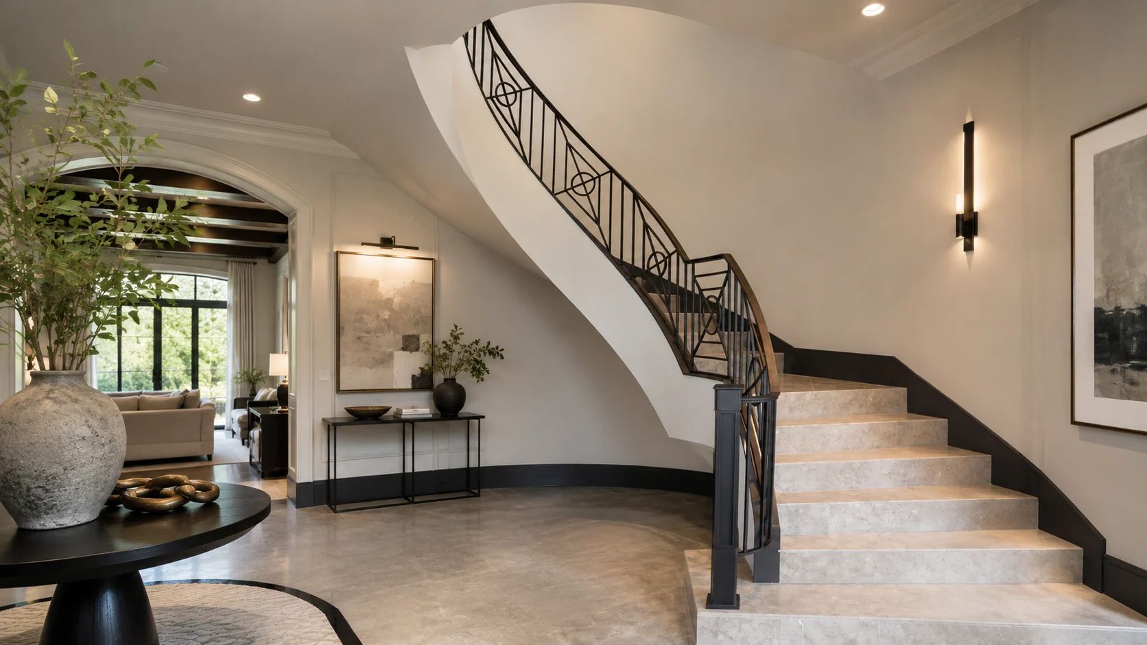 Black steel railing with geometric circular motifs along a curved stone staircase