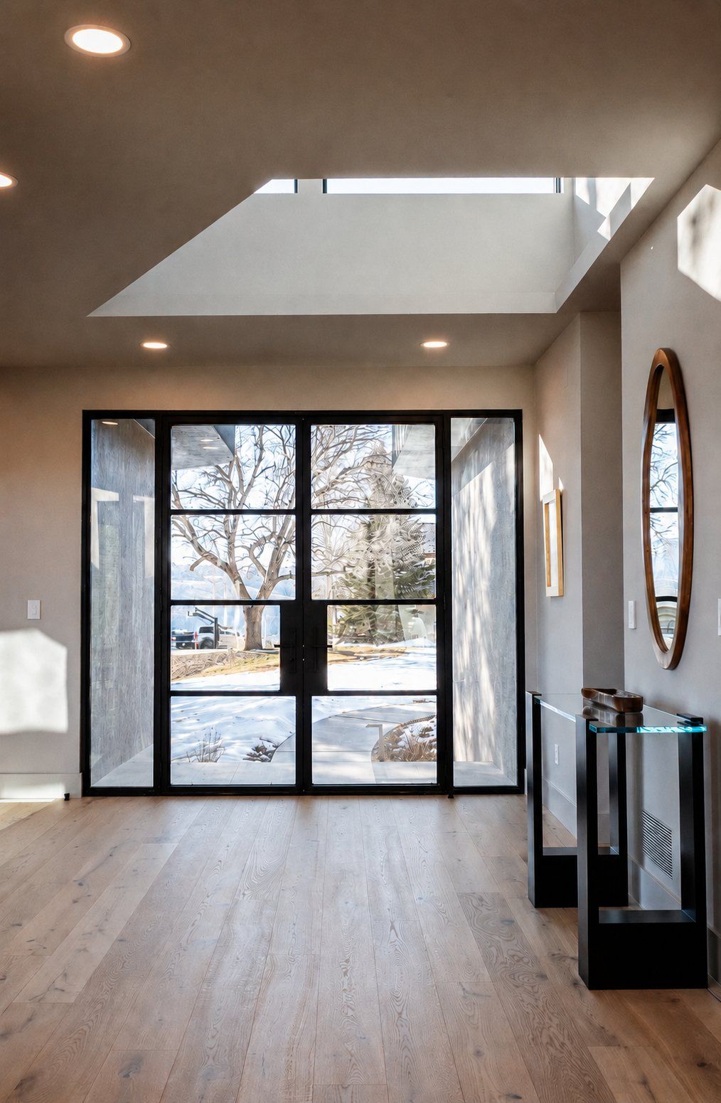 Double steel entry door with sidelights and a steel-and-glass console