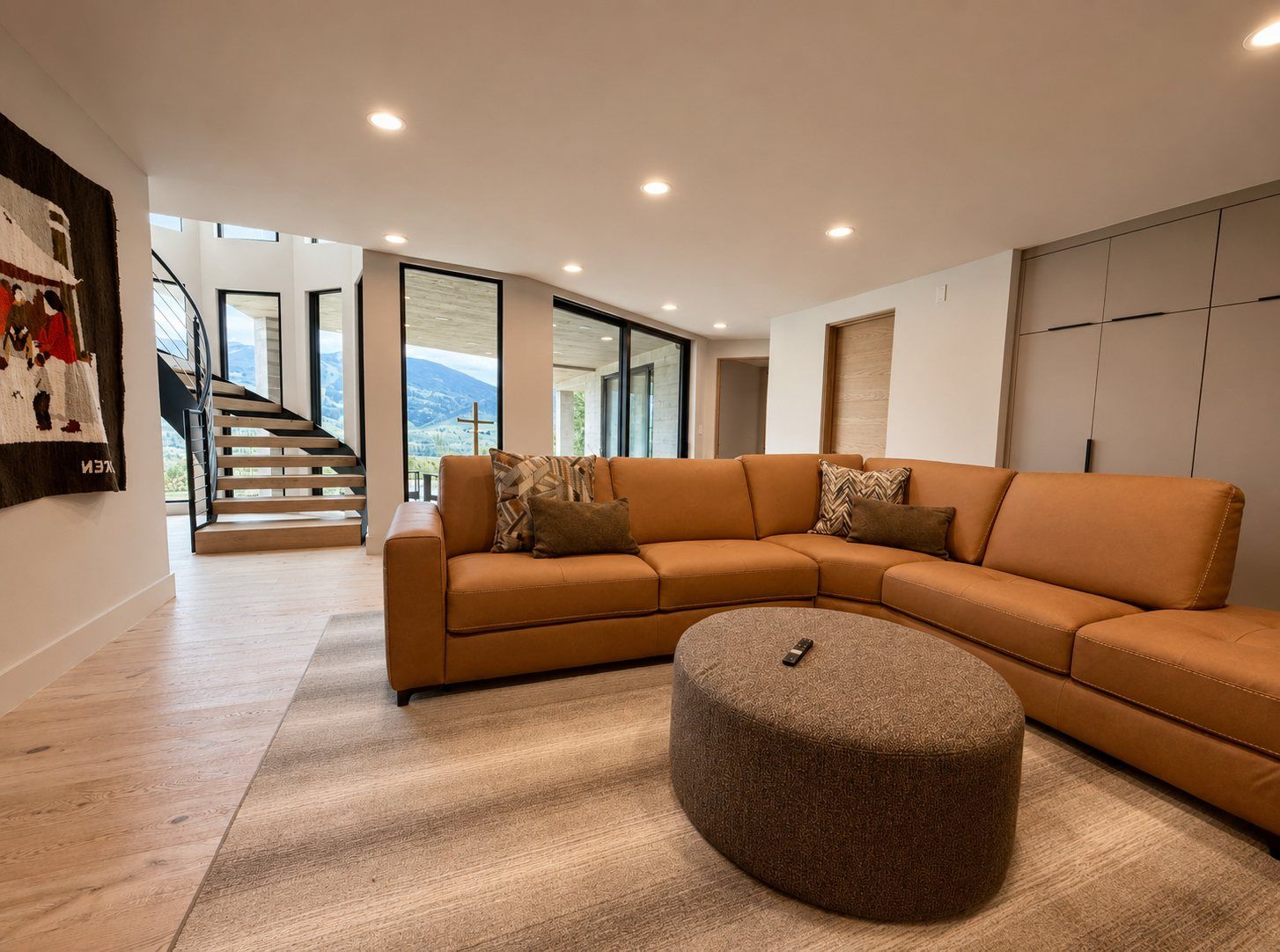 Lower-level living room with a sectional and steel doors
