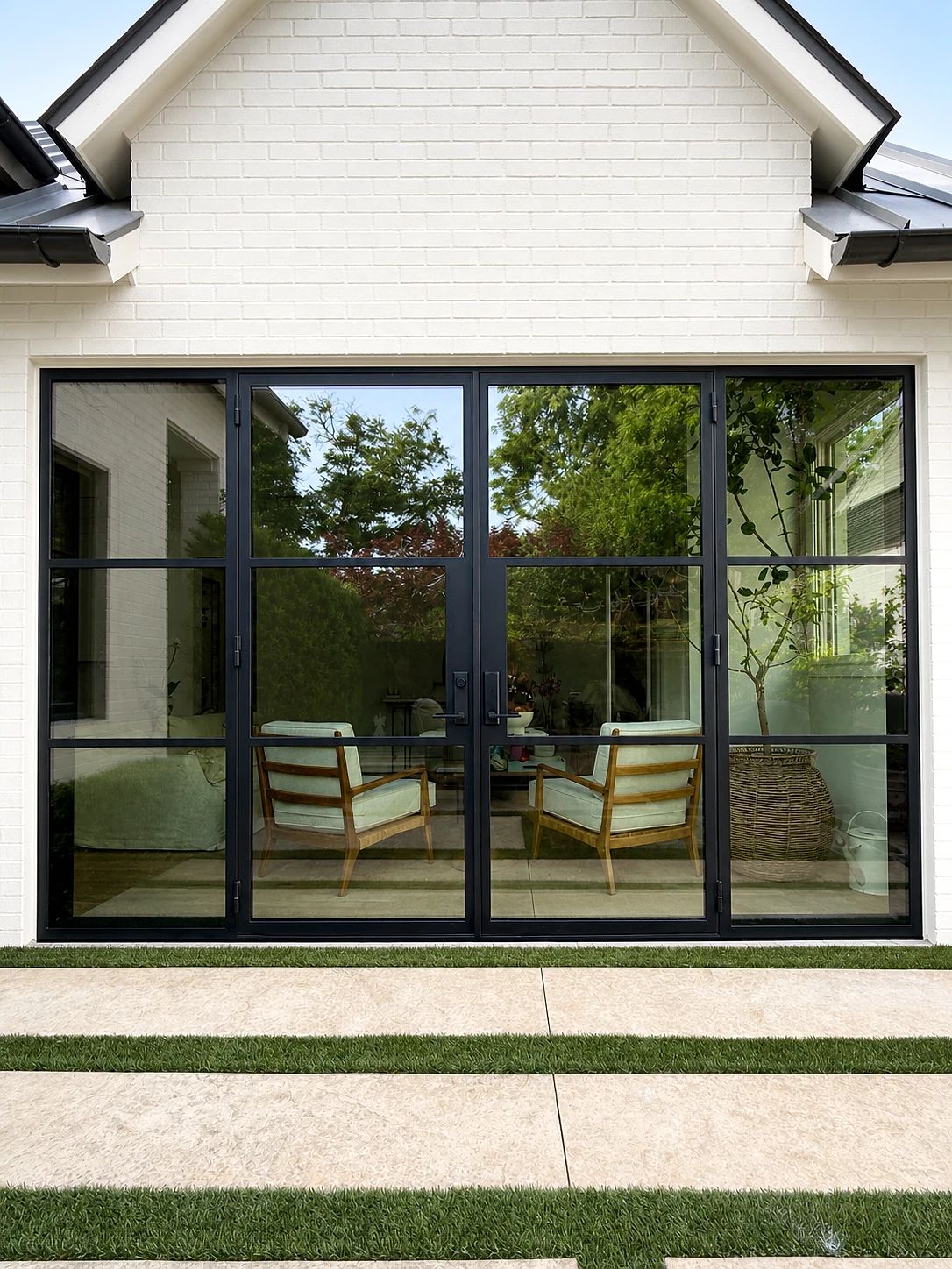 Broad black steel-and-glass patio double door with sidelights in a Highland Park courtyard