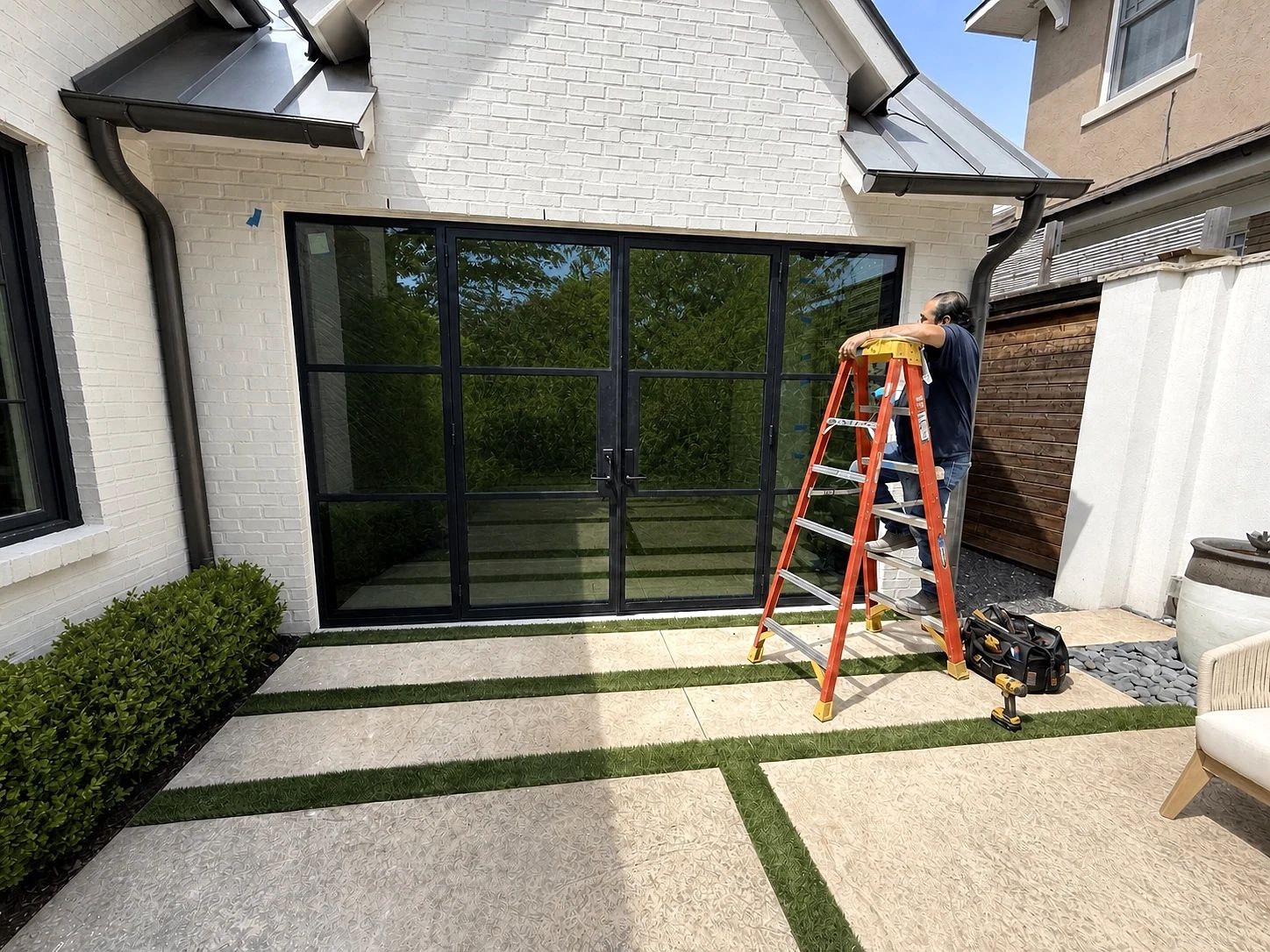 D'Hierro installer completing final adjustments on the patio steel door assembly