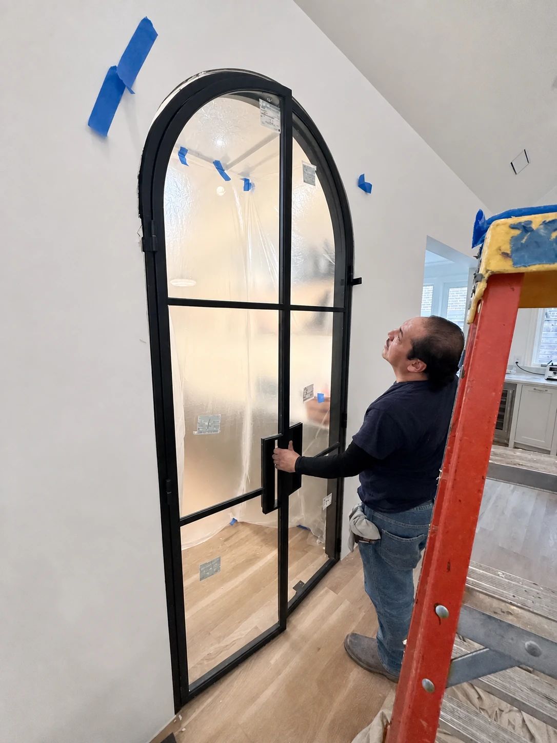 D'Hierro installer checking the fit and operation of the full-arch pantry steel door