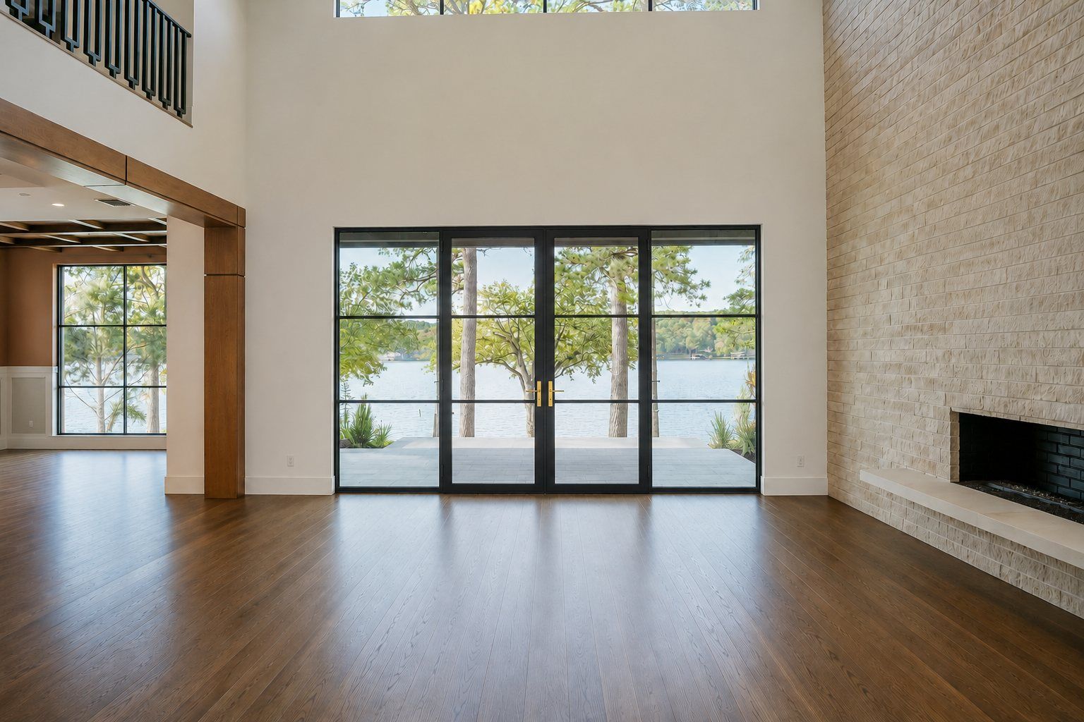 Great room with a steel window wall opening to the lake