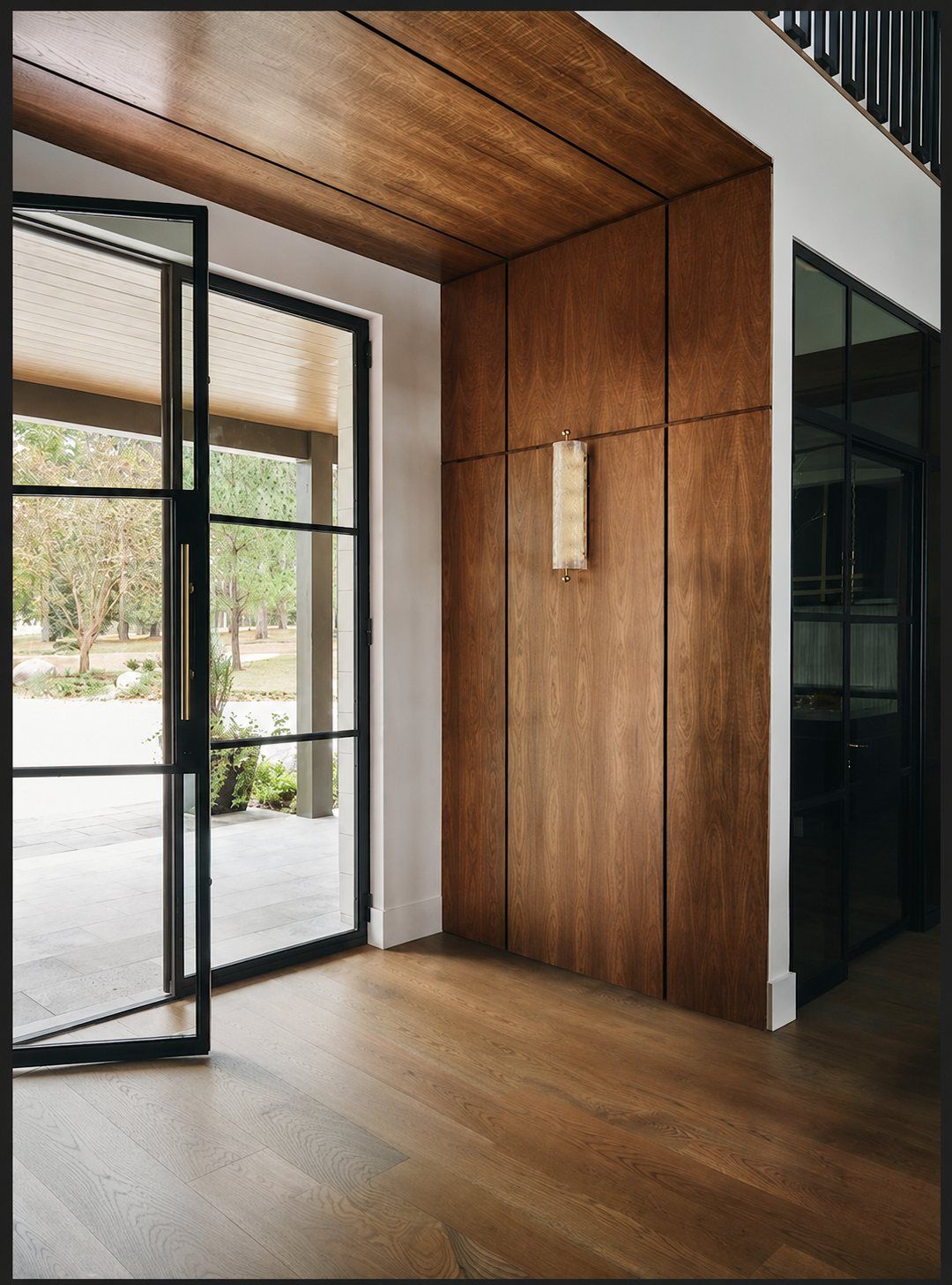Steel entry door with wood paneling