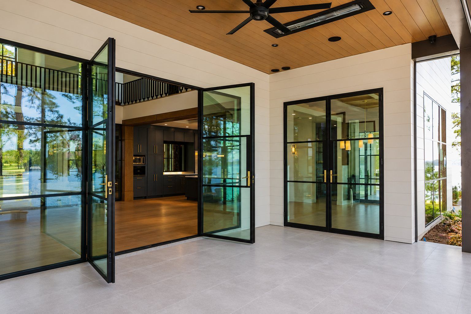Steel-and-glass doors opening to the lake