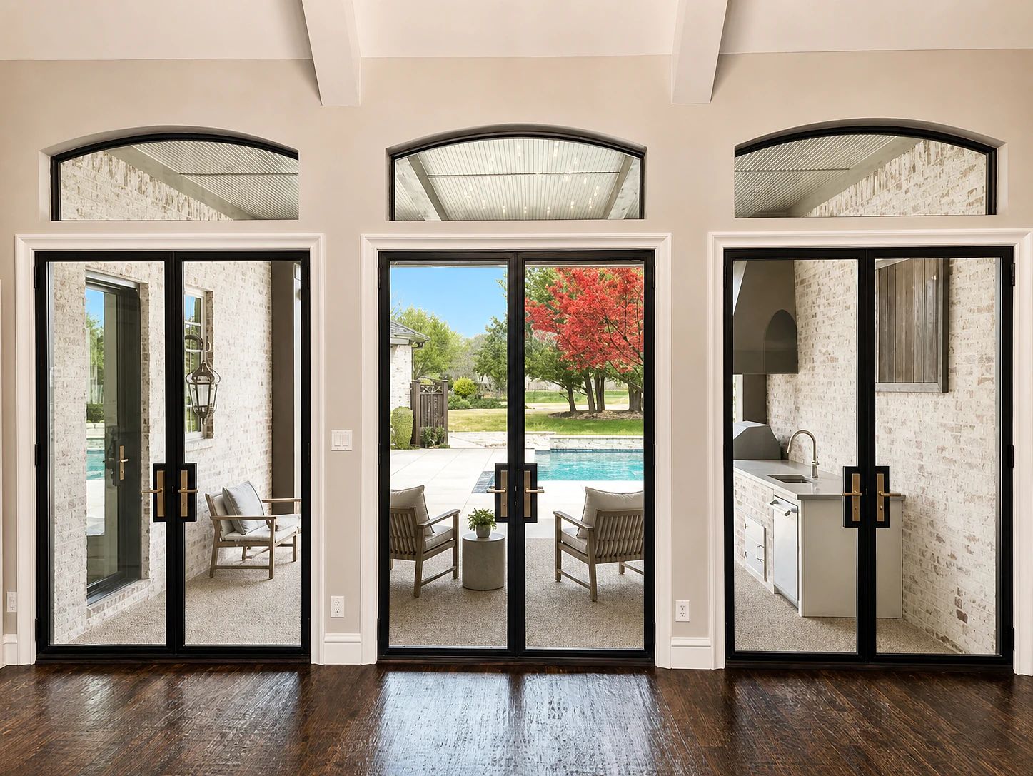 Interior view of three coordinated black steel patio door pairs and arched transoms opening to the pool in Lucas, Texas