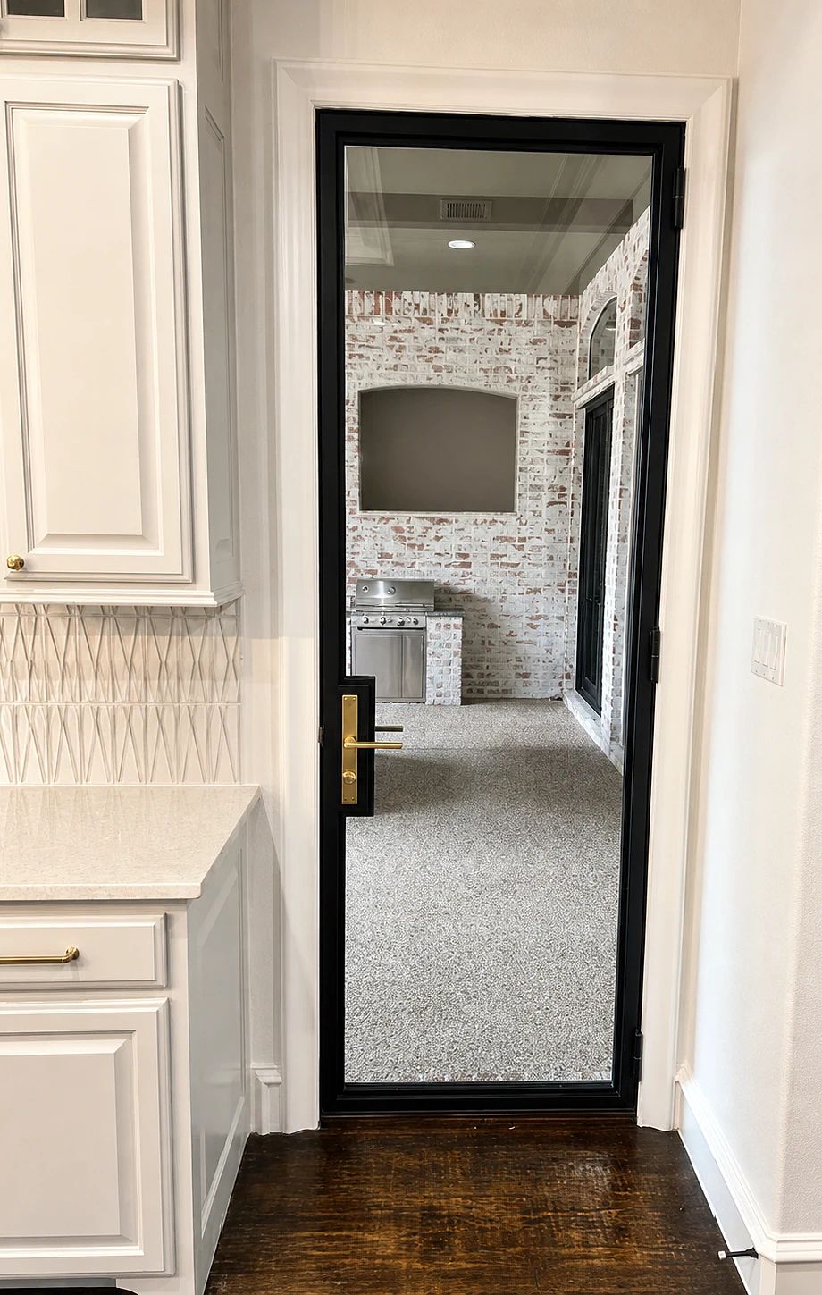 Separate black steel kitchen door coordinated with the patio assemblies in Lucas, Texas