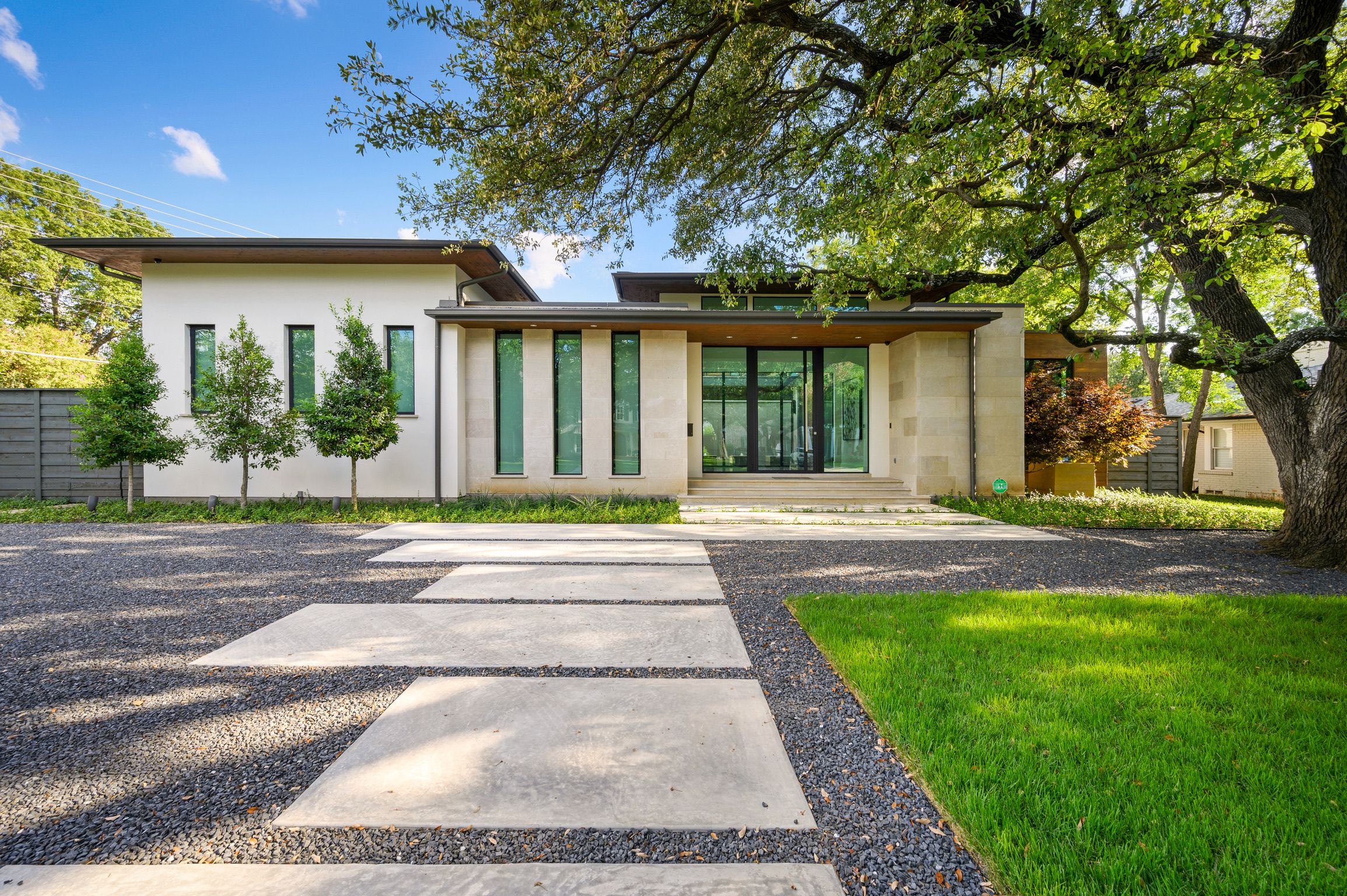Wide front facade of a modern residence with steel-framed glazing