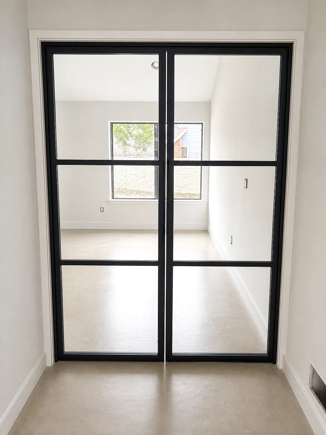 Clear-glass black steel double office doors installed in a Plano, Texas residence