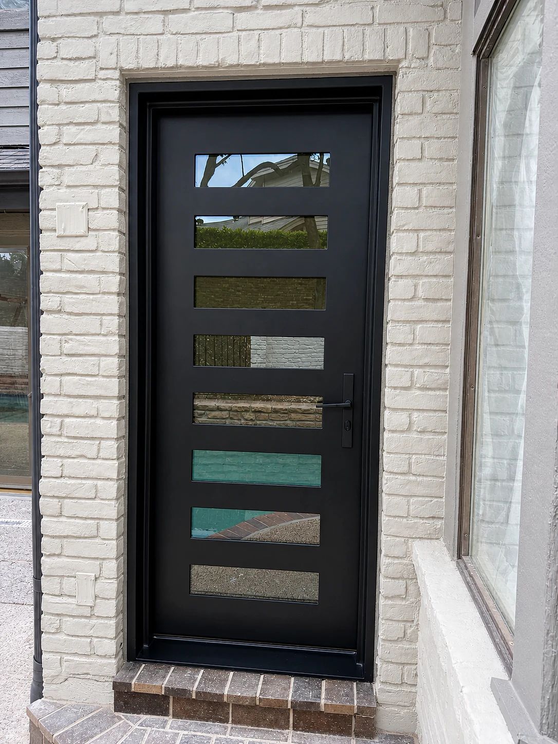 Black steel primary-suite patio door with horizontal satin-glass lites in Plano, Texas