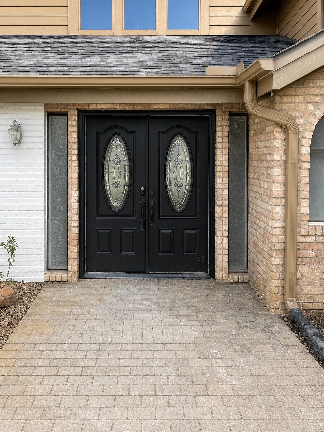 Plano front entry before replacement with black molded double doors and oval decorative glass