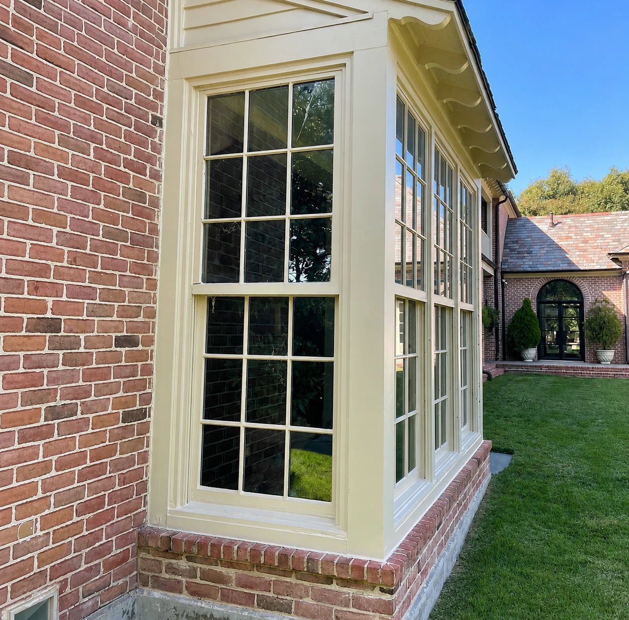 Existing white residential window box before its custom steel replacement in Plano