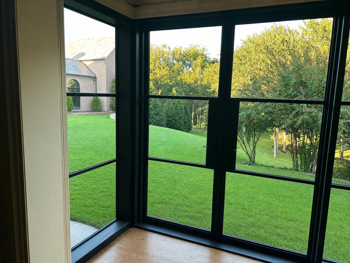 Interior view through a corner of the steel replacement window box toward the lawn