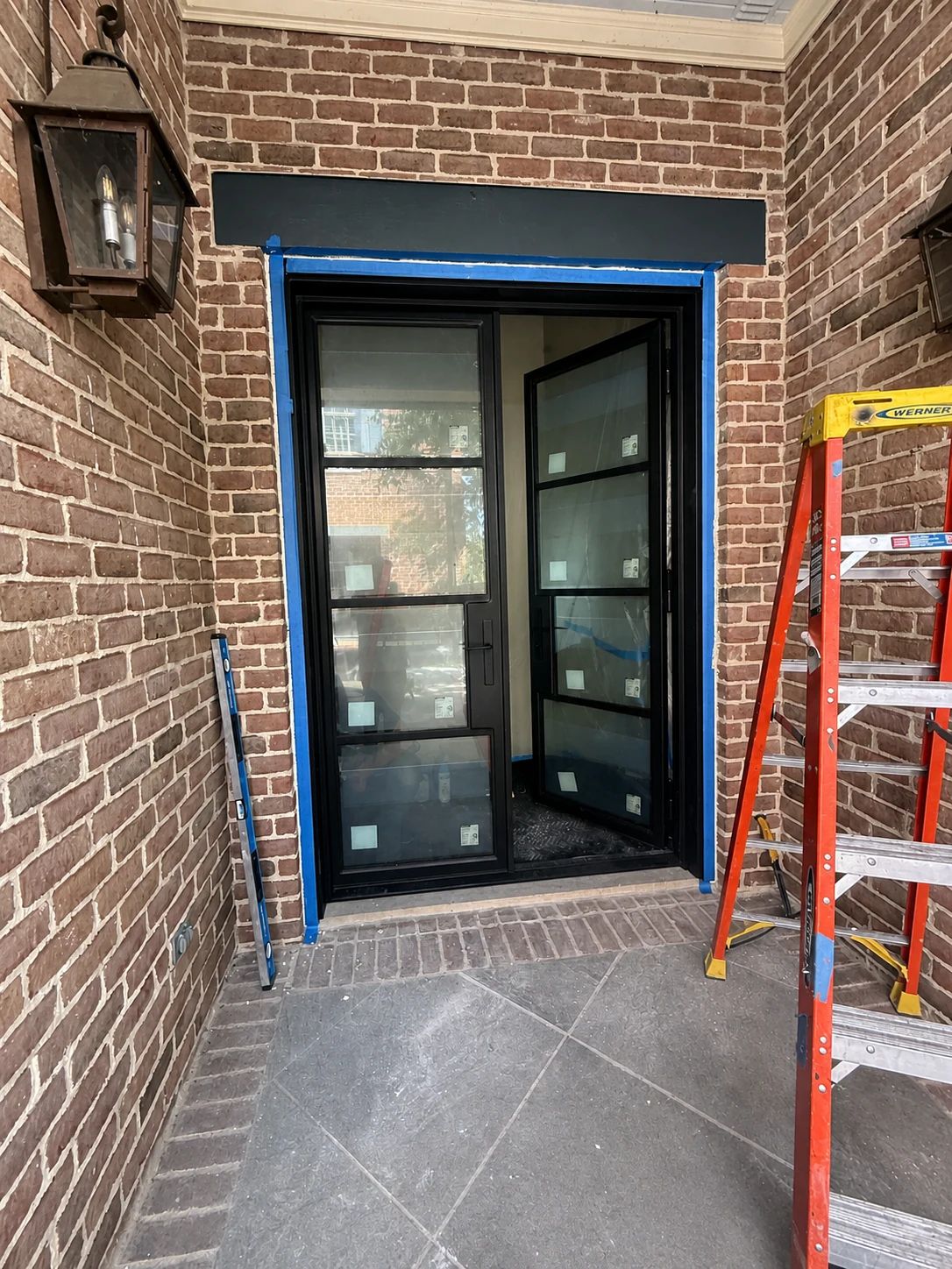 Steel window-box frame being fitted during installation at the Plano residence