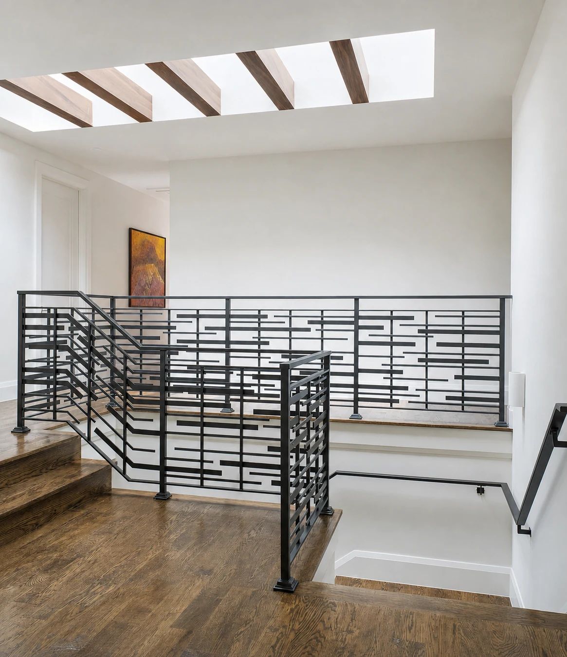 Hand-forged modern stair railing with elongated rectangular pattern in a Preston Hollow residence