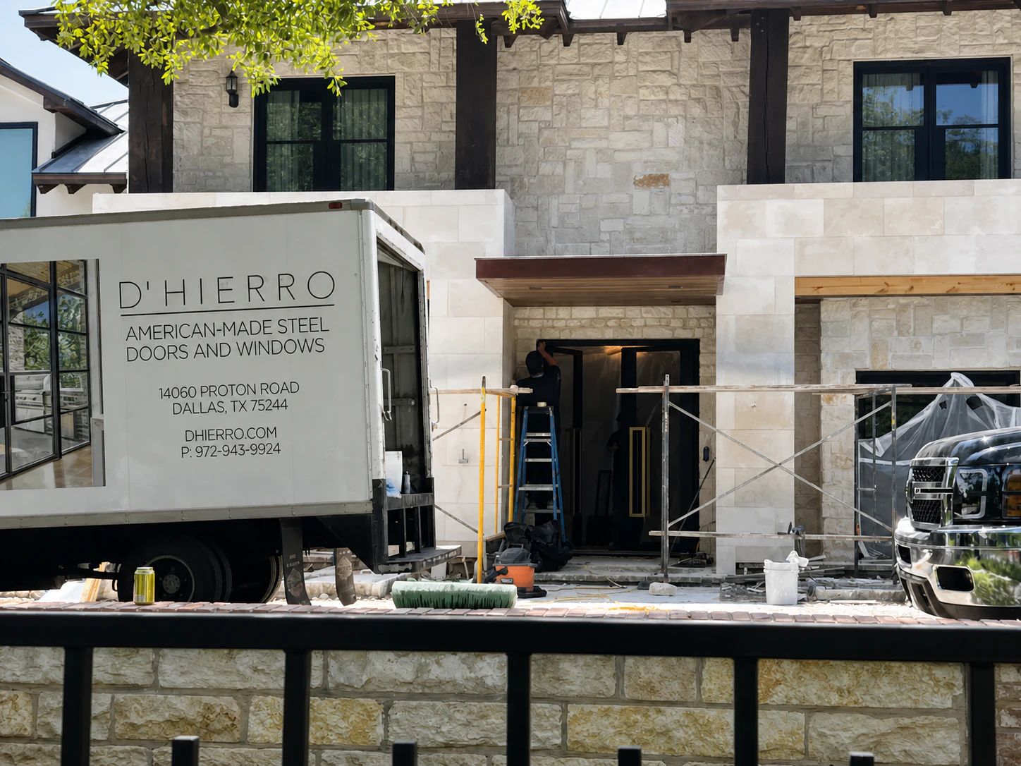 D'Hierro truck and crew installing custom black steel openings at a Preston Hollow residence