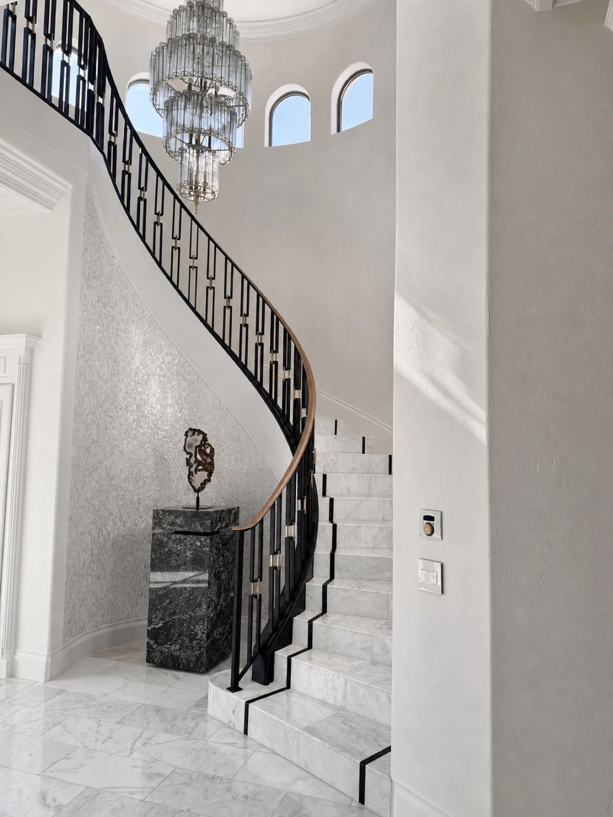 Curved interior stair railing following a sweeping run of stairs