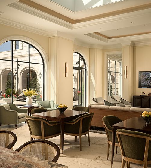 Garden-room dining beneath arched steel windows