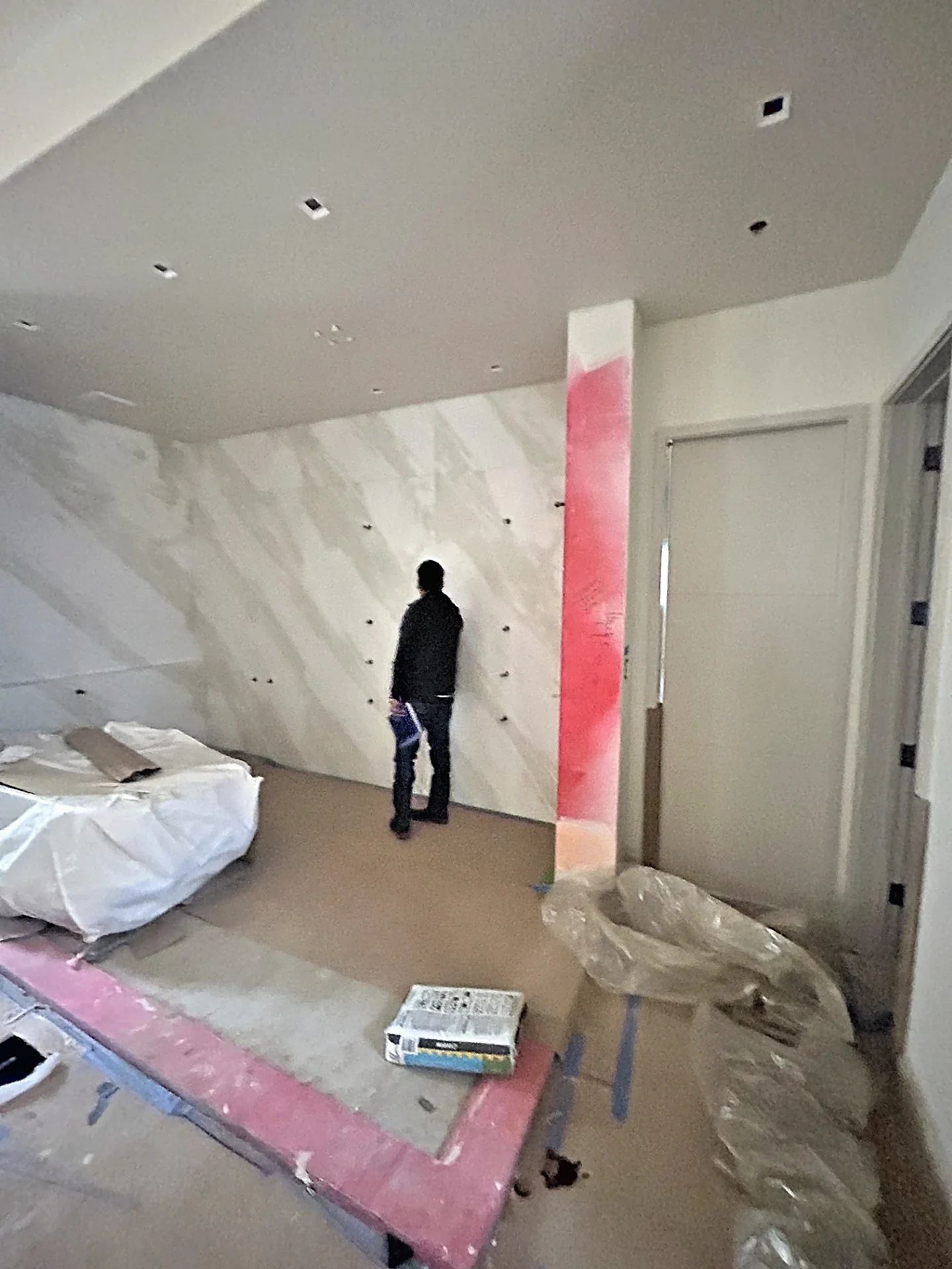 Field verification of the marble wet room opening before fabrication of the custom steel shower enclosure