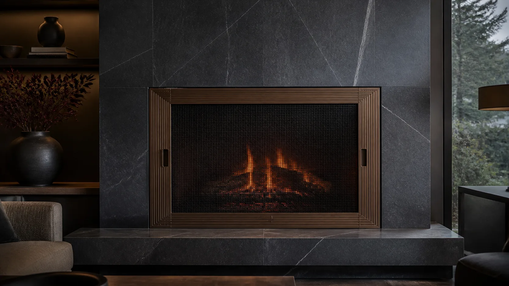 Ribbed bronze mesh fireplace screen against a monolithic stone hearth