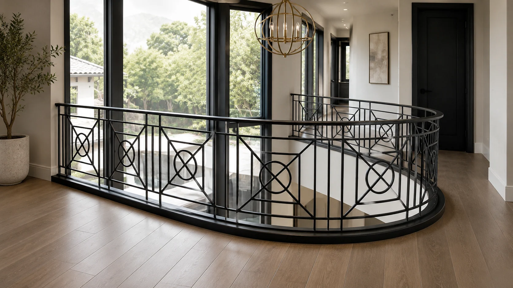 Curved interior landing with decorative custom iron railing