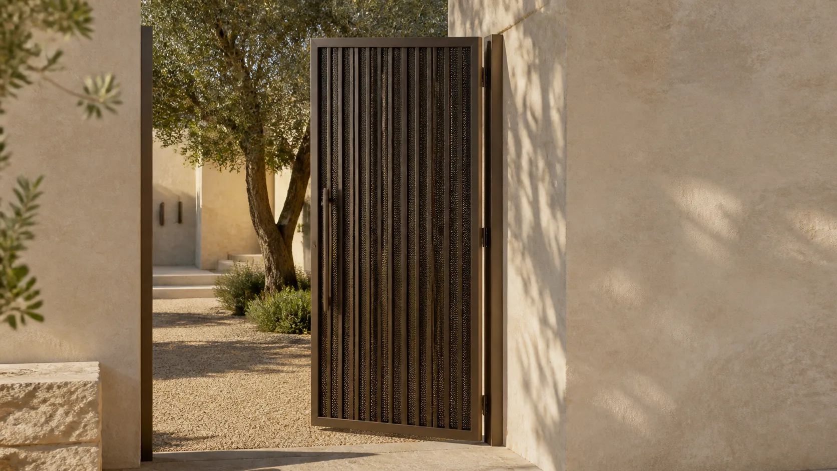Warm-bronze privacy gate opening into a landscaped courtyard