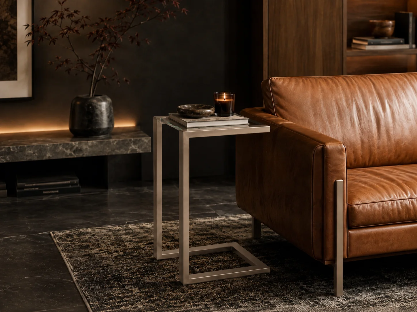 Milan Hugging Side Table by D'Hierro — Warm Silver finish, styled beside a leather sofa